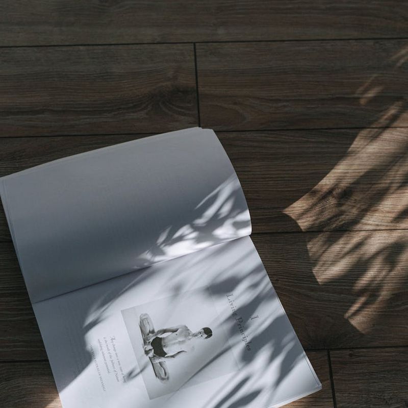 A large, minimalist yoga studio with natural wood floors.